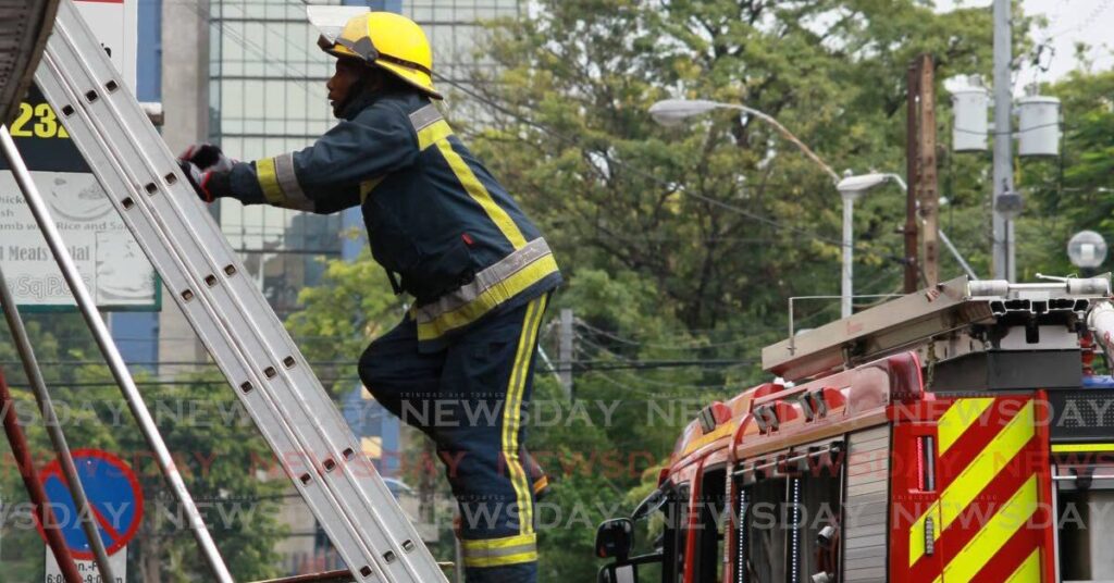 A fire officer responds to a fire in downtown Port of Spain. - File photo by Roger Jacob