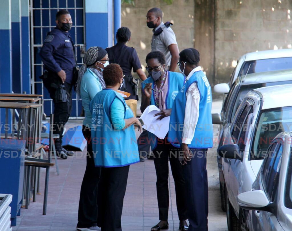 In this file photo, Election and Boundaries Commission workers on duty during polling day in January 2021.  - Photo by Ayanna Kinsale