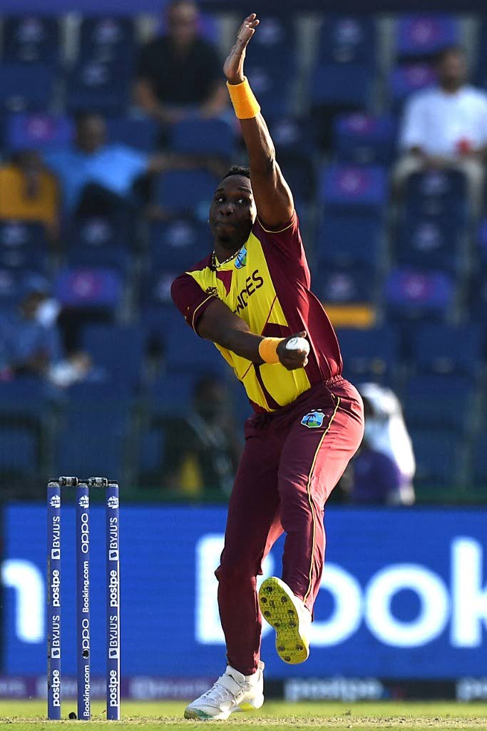  In this November 6, 2021 file photo, West Indies' Dwayne Bravo bowls during the ICC men's Twenty20 World Cup match against Australia and West Indies at the Sheikh Zayed Cricket Stadium in Abu Dhabi. - 