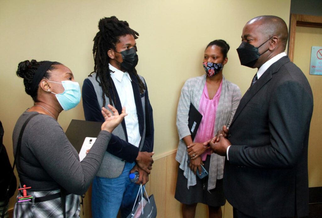 Minister of Youth Development and National Service Foster Cummings speaks with past program participants. - Photo courtesy of Ministry of Youth Development and National Service