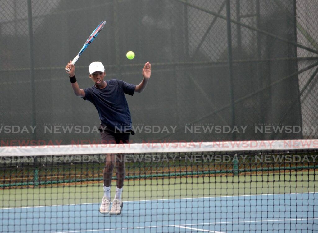 FILE PHOTO: A tennis player plays a shot at the National Racquet Centre in Tacarigua. - 