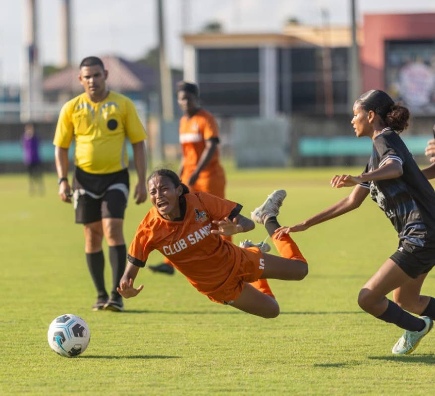 Club Sando's Alexcia Ali, left, is fouled by an Atlas Athletic player in a TT WoLF game at the Manny Ramjohn Stadium, Marabella. - File photo courtesy WoLF
