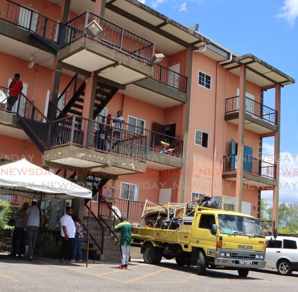 Workers remove furniture and other belonging from an HDC development at Cyprus Hill, San Fernando on April 30, after the homeowners were evicted for failing to pay an outstanding debt. - Photo by Angelo Marcelle