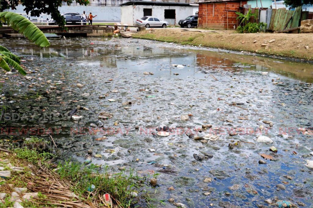 The canal that separates phase one and two of Beetham Gardens filled with debris and sewer water. - Photo by Venessa Mohammed