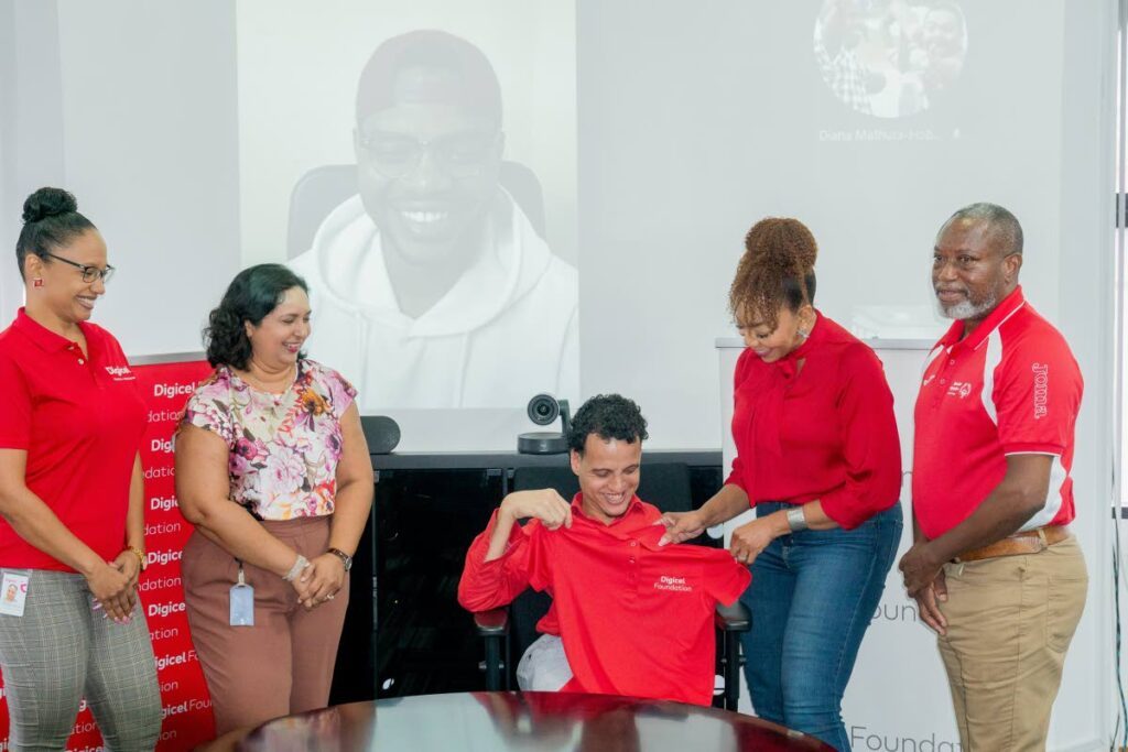 Digicel Foundation CEO Penny Gomez (second from right) presidents Digicel Foundation endorsee and 94.1 FM's DJ Joe Brien with a shirt at the launch of the 2024 Special Olympics TT National Games on Wednesday. Photo courtesy Digicel Foundation.  - 