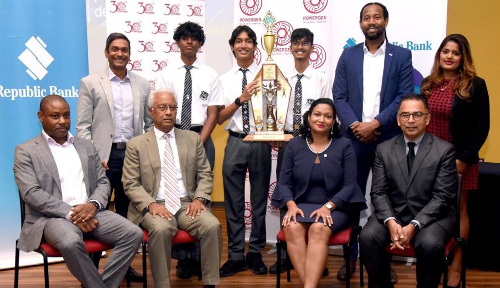 Sharing a proud moment with the winning team from Naparima College the judges are joined by Ryun Singh (back, left) and Krystle Maharaj (back, right). - 