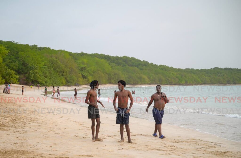 People enjoy a day of relaxing at Buccoo beach on May 5, two days after it was reopened following a shark attack at Turtle Beach on April 26. - Visuals Style