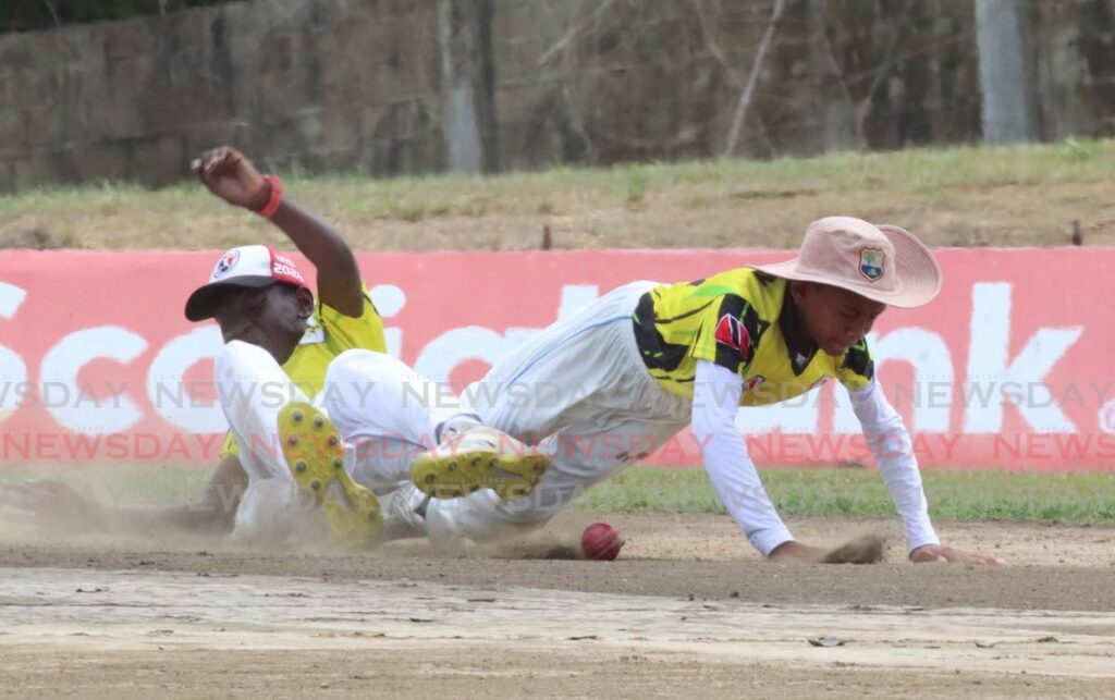Two Central Zone players scramble for the ball during their team's match against North Zone, in the TT Cricket Board's Under-13 inter zone semi-final, at the National Cricket Centre, Couva on May 7, 2024. - Angelo Marcelle