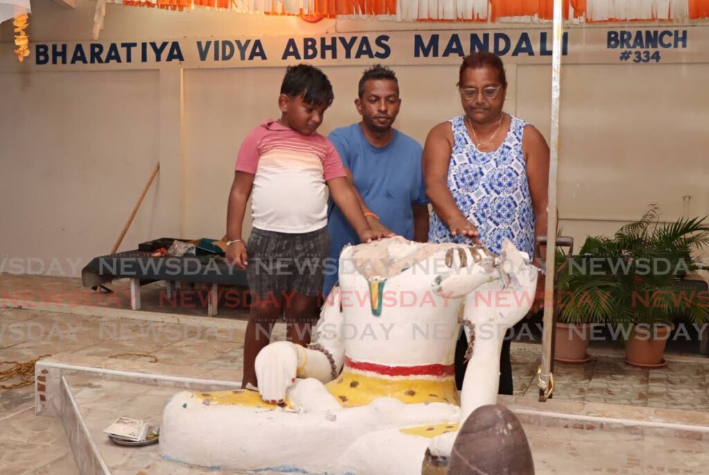 GOODBYE: Devotees of the Bharatiya Vidya Abhyas Mandali temple on Watts Street, Curepe say goodbye to a murti of Lord Shiva, which was destroyed by vandals on Wednesday morning. The murti was donated to the temple 32 years ago and had to be removed after the attack.  - AYANNA KINSALE