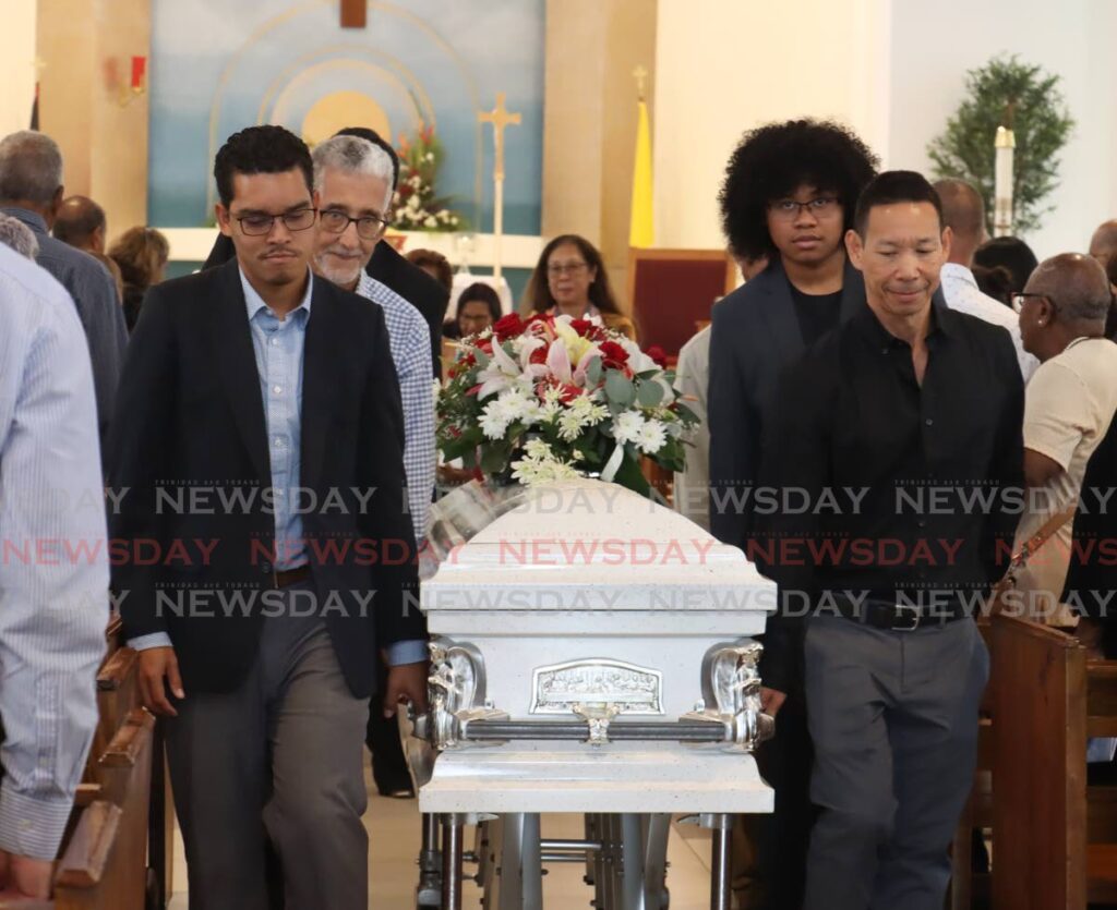 FAREWELL: Pall-bearers guide the casket bearing the body of Prof Emeritus Dr David Picou during Picou's funeral at the St Mary's RC Church, on George Cabral Street, St James on May 9. - Photo by Faith Ayoung