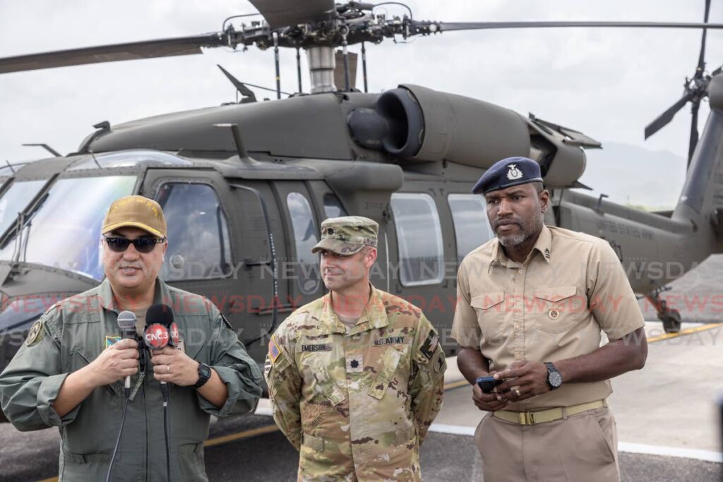 From left, Senior US Defence Official/Defence Attaché to TT Commander Richard Reyes, Delaware National Guard task force aviation commander Lieutenant Colonel Thomas Emerson and TTDF communications manager Lieutenant Sherron Manswell, address the media in front of one of the three Delaware National Guard Black Hawk helicopters at Piarco International Airport on May 9. - Photo by Jeff K Mayers