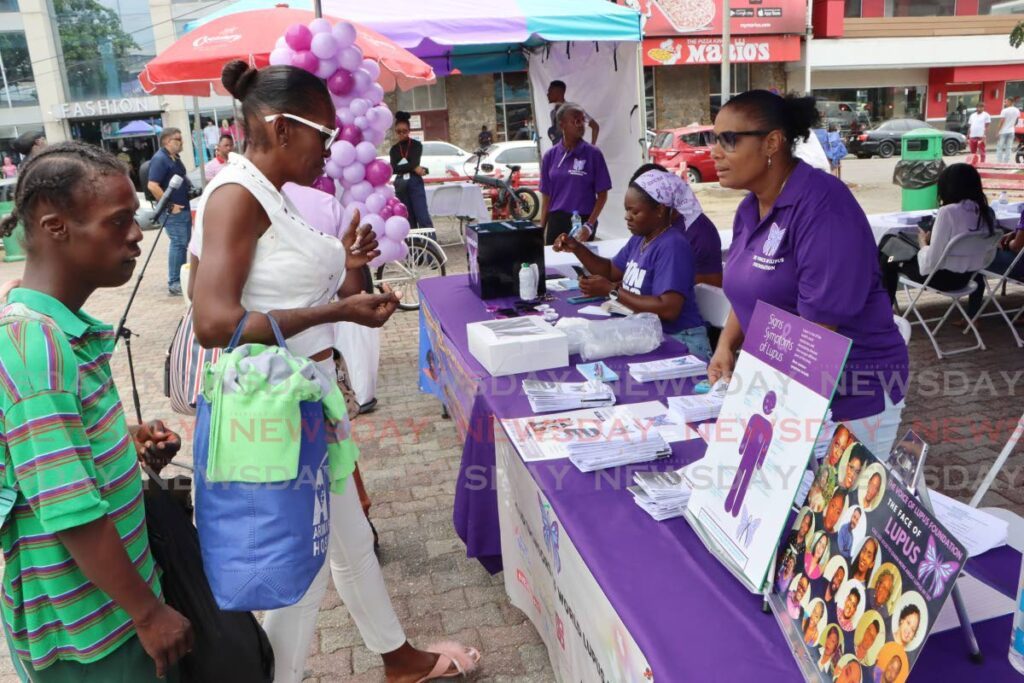 Members of The Voice of Lupus Foundation educate members of the public on World Lupus Day, at the Brian Lara Promenade, Port of Spain, on May 10. 