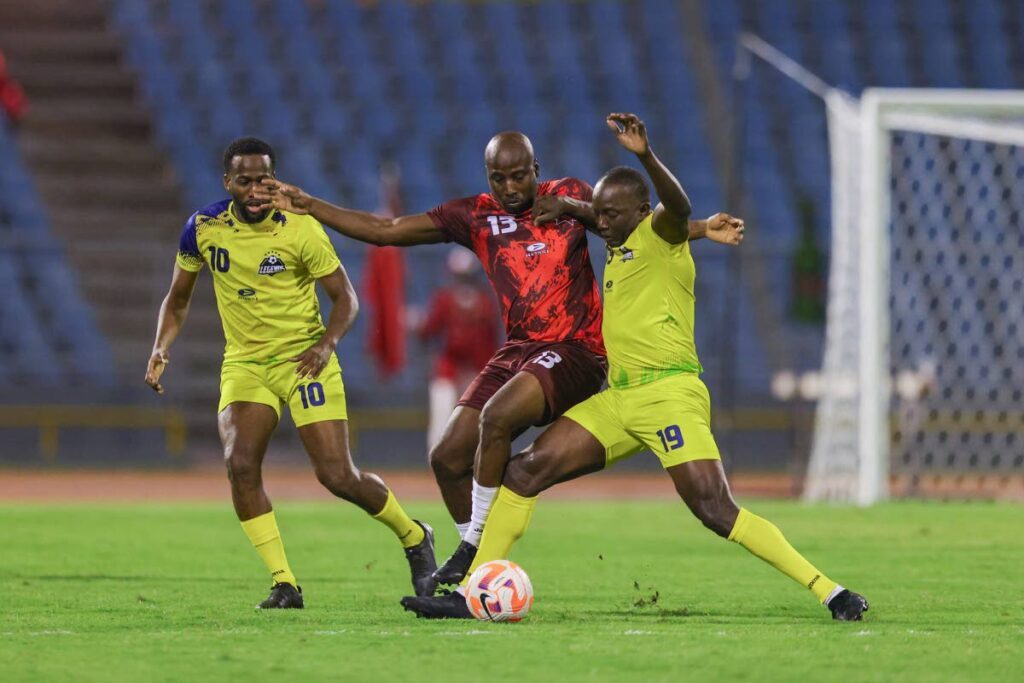 Former Trinidad and Tobago and Manchester United striker Dwight Yorke (R) and former TT forward Cornell Glen vie for possession during the Legends vs TT All-Stars match, on May 10, 2024, at the Hasely Crawford Stadium, Port of Spain.  - Daniel Prentice
