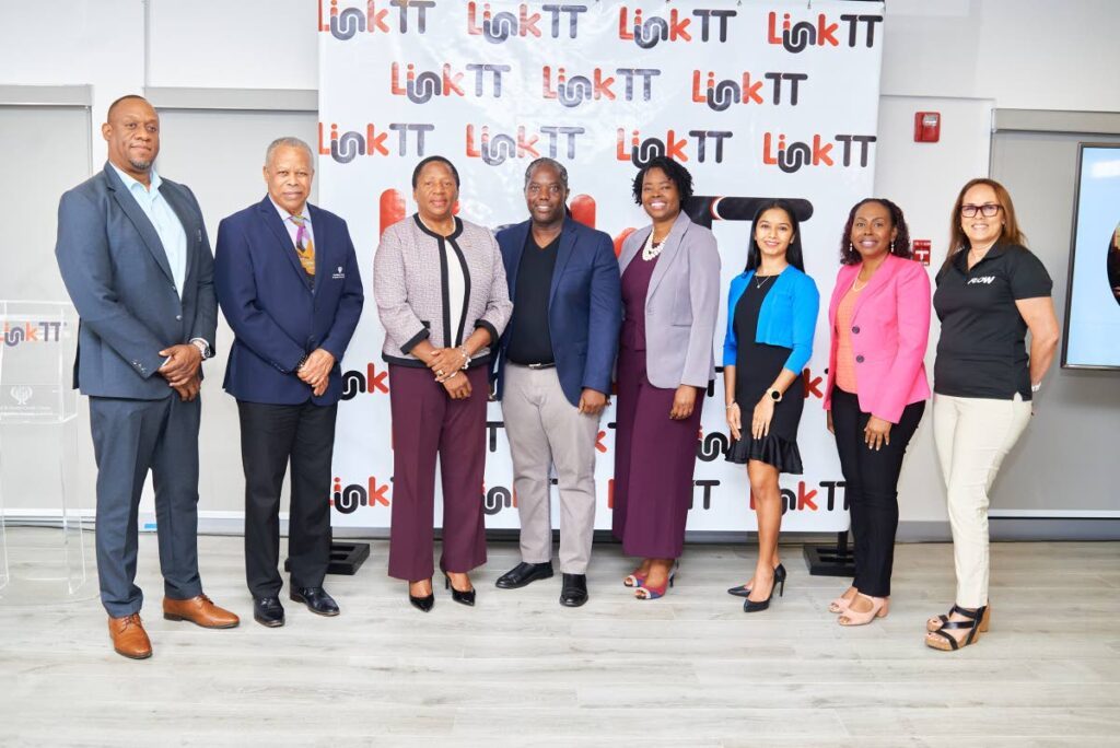 Minister Pennelope Beckles-Robinson (third from left) takes a photo with the LinkTT Partners (from left to right) - Niall Legerton, John Victor, Kenwyn Peters, Rae Ann George, Meranda Ramoutar, Genevieve Julien and Roberta Norman-Reverand.  - Photo courtesy George Pont