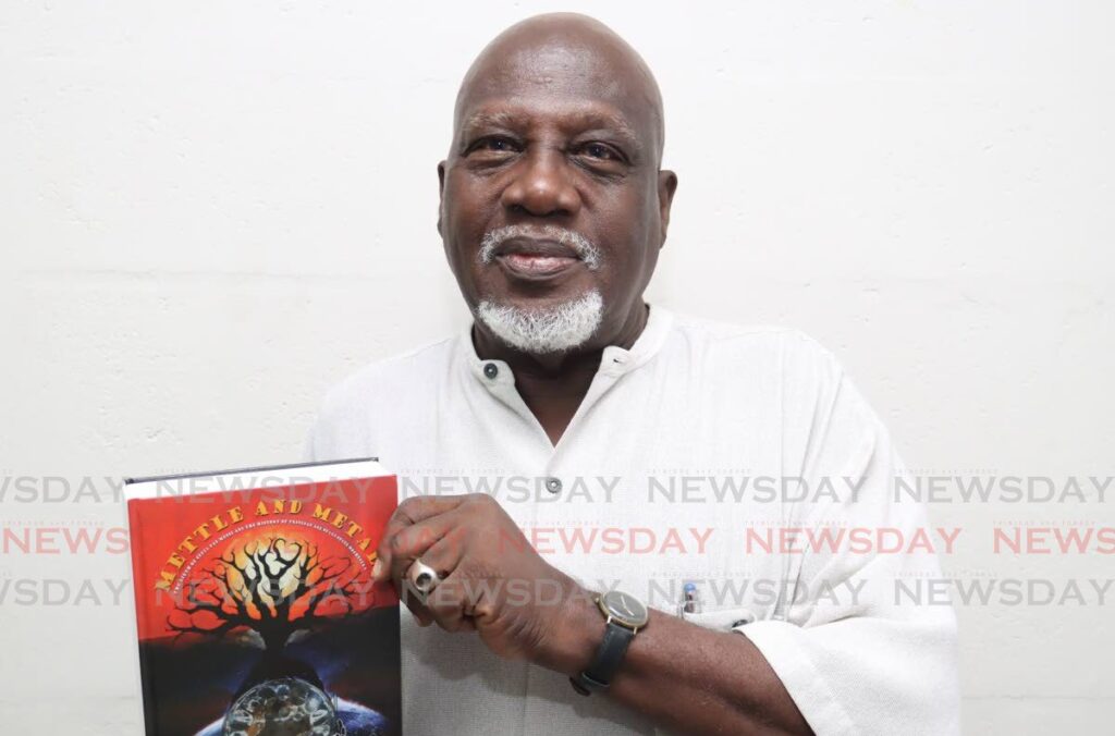 Author A Bukka Rennie with his latest book Mettle and Metal at the Massy All Stars panyard, Duke Street, Port of Spain, on May 13. - Photo by Faith Ayoung