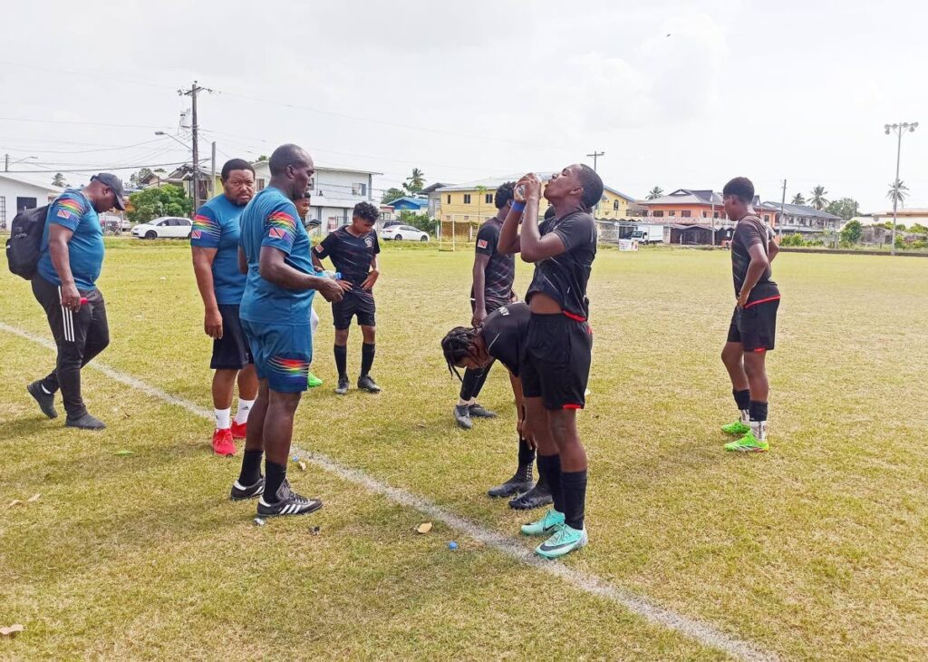 Players from Cox Coaching School pause for a water break during their NLCL under-15 community cup game against HVC FC in Caroni on May 11. - Photo courtesy NLCL