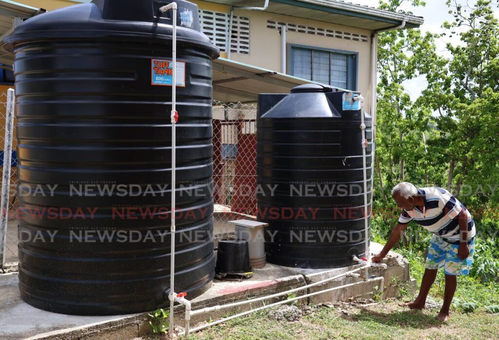 Keshan Jamuna opens a water valve at his home in Diamond Village showing that there is no water flowing out of it on May 14. The valve is connected the WASA main meant to supply the village. - Photo by Venessa Mohammed