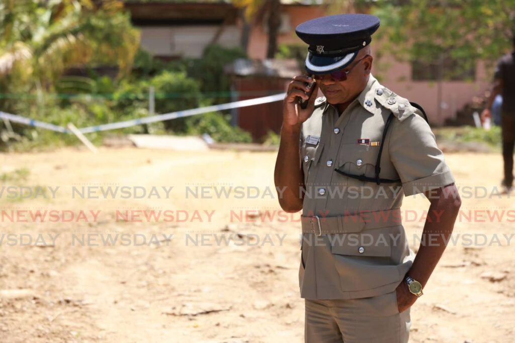 Snr Supt Richard Smith, head of the North Central Police Division, at a crime scene in Dookiesingh Street, St Augustine on May 15.  - Photo by Jeff K Mayers