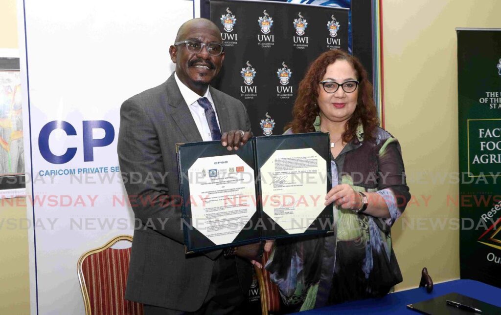 Caricom Caribbean Private Sector Organisation CEO and technical director Dr Patrick Antoine and UWI St Augustine principal Rose Marie-Belle Antoine display the signed memorandum of understanding to establish a consortium for agricultural research at UWI St Augustine on May 15. PHOTO COURTESY UWI - 