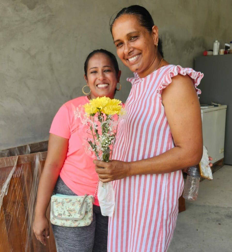 Veda Maraj of the Mafeking Community Council presents a bouquet to a happy mom.