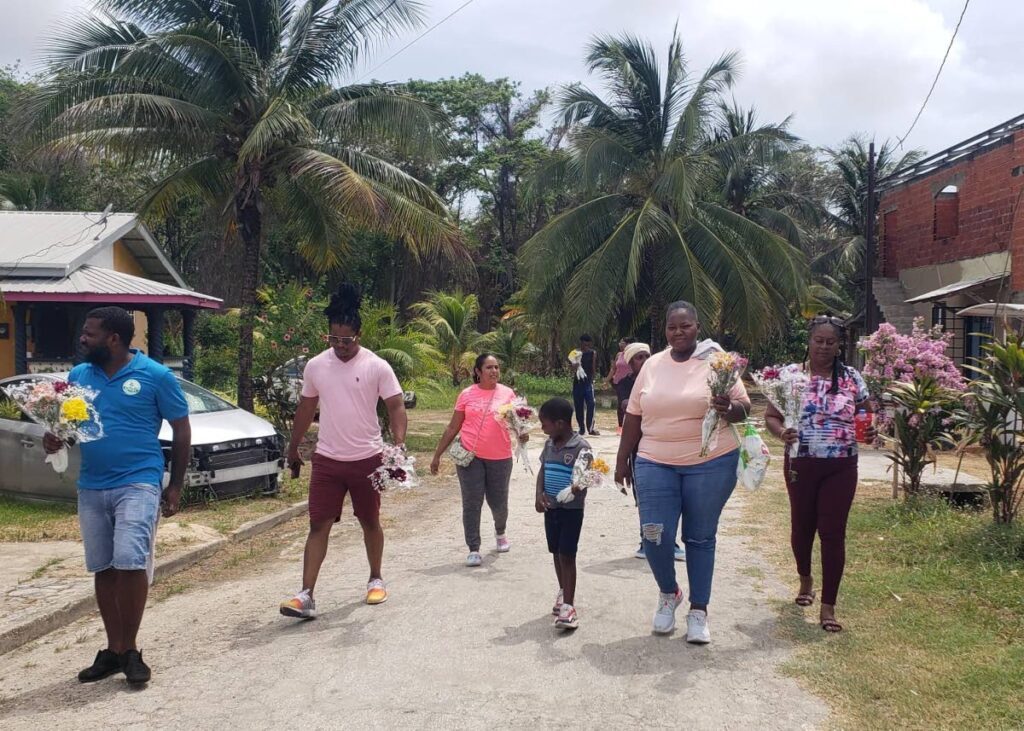 Members of the Mafeking Community Council hit the road to deliver flowers to mothers in Mafeking Village, Mayaro. 
