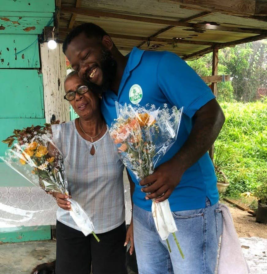 A Mafeking mom receives a bouquet from Peter Licorish of the Mafeking Community Council. 