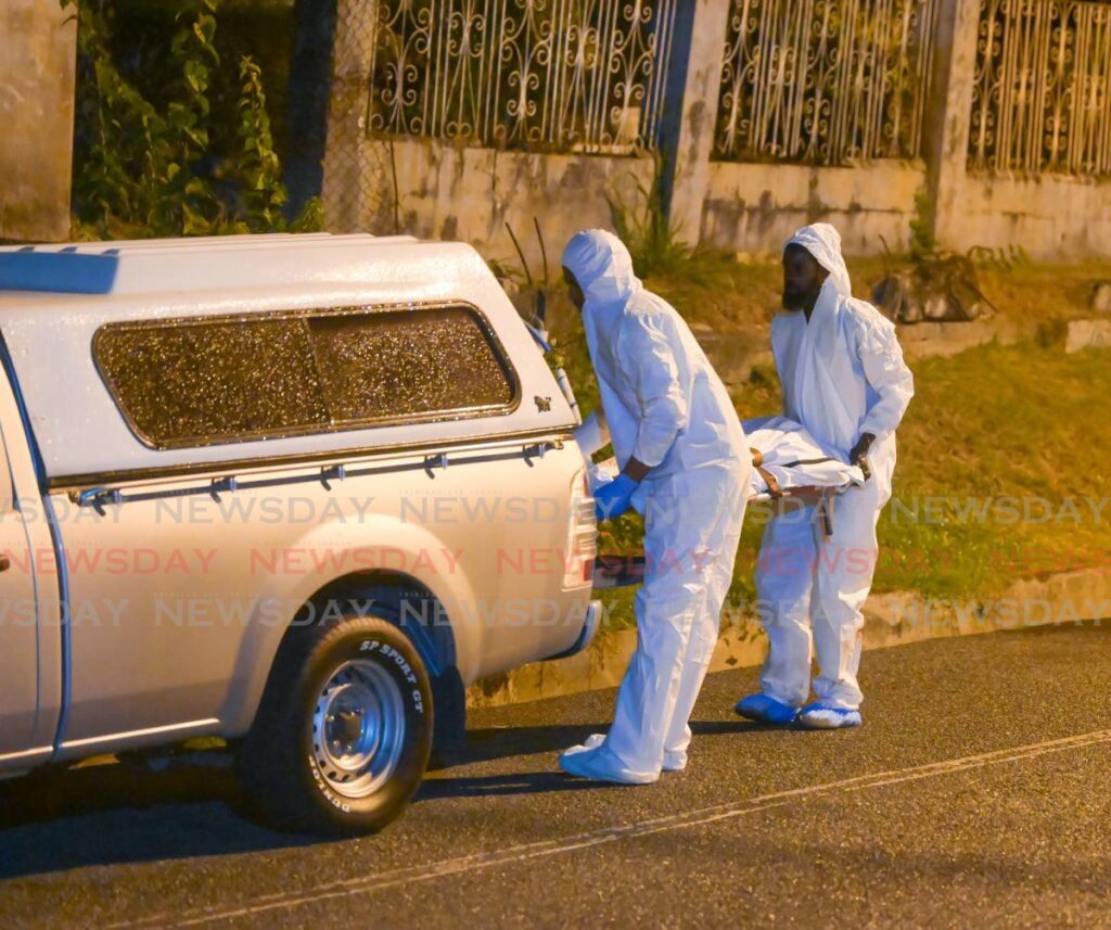 In this file photo, undertakers remove the body of Samuel 