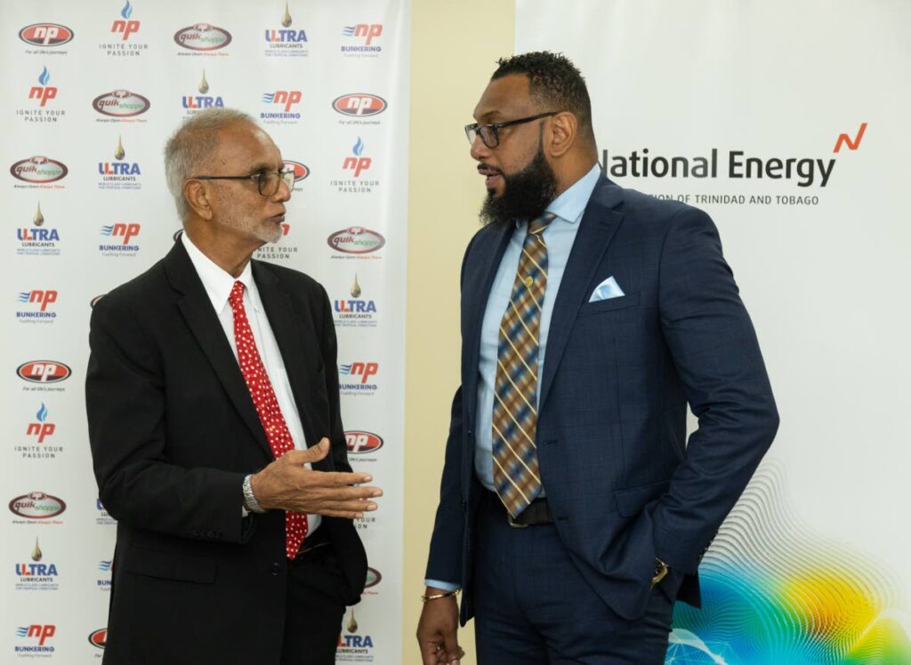NP chairman Sahid Hosein, left, chats with Dr Joseph Khan, chairman of National Energy at an MoU signing to enhance energy efficiency at NP’s facilities on May 23. - 