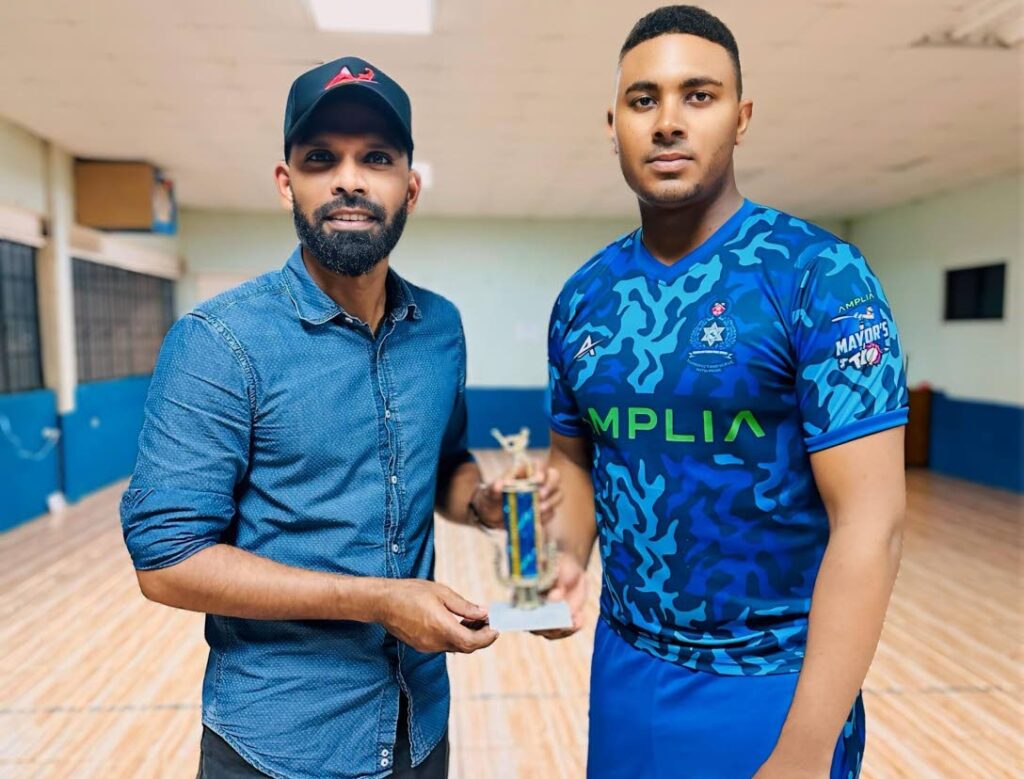 Police player Saiba Batoosingh (right) receives his Man of the Match award from Chaguanas mayor Faaiq Mohammed for his performace against Marchin Patriots in the Amplia Chaguanas Mayor's T10 Cup on May 22. - Photo courtesy Amplia. 