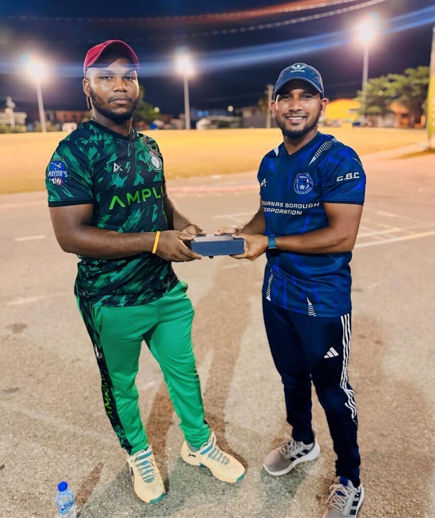 Prisons player Adrian Cooper (L) receives his Man of the Match award from Chaguanas councillor Adrian Ali for his effort against Pierre Road Sports in the Amplia Chaguanas Mayor's T10 Cup on May 22.