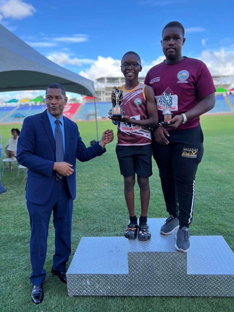 Tobago youngsters Azzirion Williams (C) and Kellon Potts (R) show off their respective Victor Ludorum awards at the 2024 NGC National Primary Schools track and field championship on May 22. Photo courtesy the THA’s Division of Education, Research and Technology.  - 