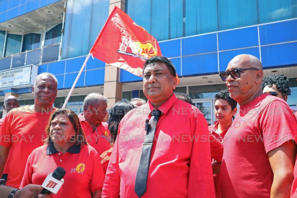 PNM candidate for the Quinam/Morne Diablo district Anderson Nanan, centre, speaks to the media after filing his nomination papers at the EBC’s Penal/Debe registration area sub-office in Penal on May 24. - Photo by Venessa Mohammed