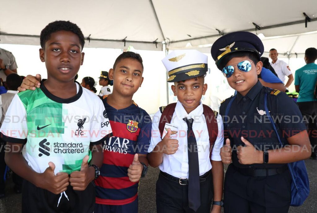 FUTURE STARS: Cole Joseph, ten, left, and Aidan Khan, 11, both decked off in football gear, while Alejandre Montano, ten, and Caleb McIntyre, 11, right, wear pilot uniforms during career day on Friday at the Penal Presbyterian Primary School. PHOTO BY VENESSA MOHAMMED - Venessa Mohammed