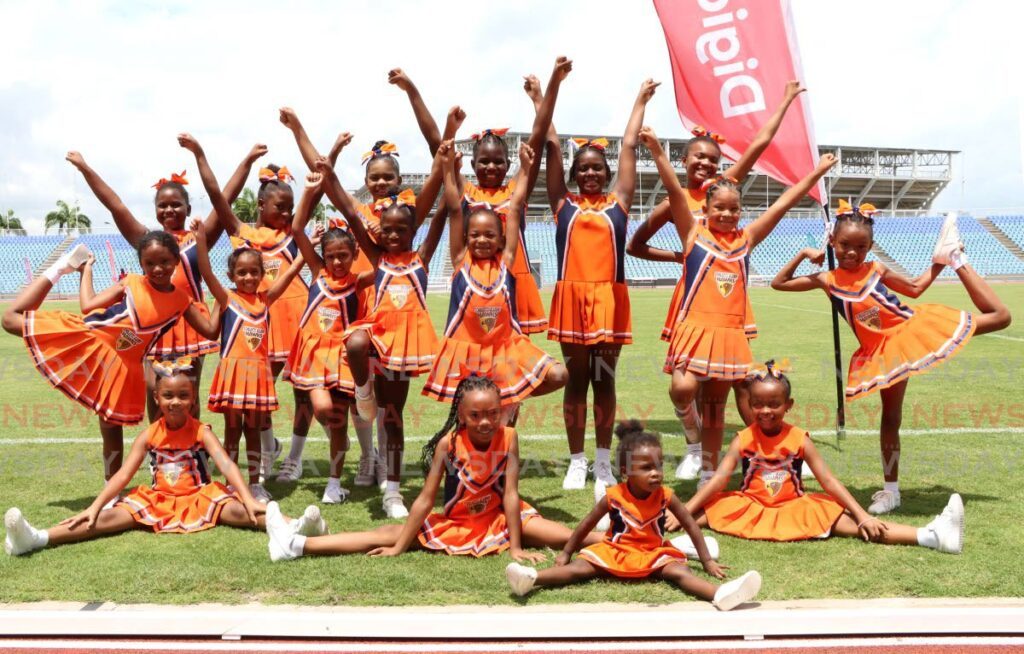 BRING IT ON: Members of the Scholastic Academy Hawks cheerleader squad pose for a photo during the Special Olympics football event at the Hasely Crawford Stadium, Mucurapo. - Photo by Ayanna Kinsale