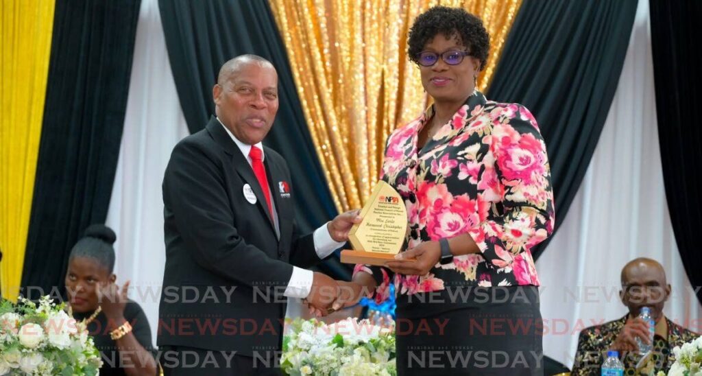 National PTA president Walter Stewart presents a token to Commissioner of Police Erla Harewood-Christopher at the NPTA mid year convention at the Lowlands Multipurpose Centre, Lowlands on May 25. - 
