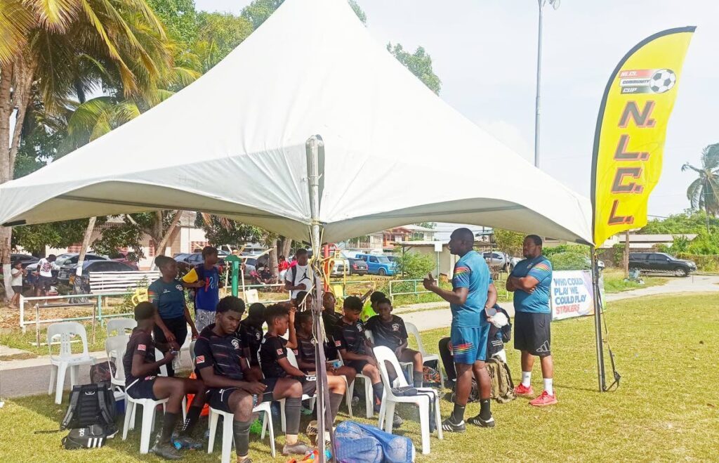 Cox Coaching School's Dennis Cox speaks to his players during a Next Level Consulting Ltd (NLCL) Under-15 Community Cup match. - Photo courtesy NLCL