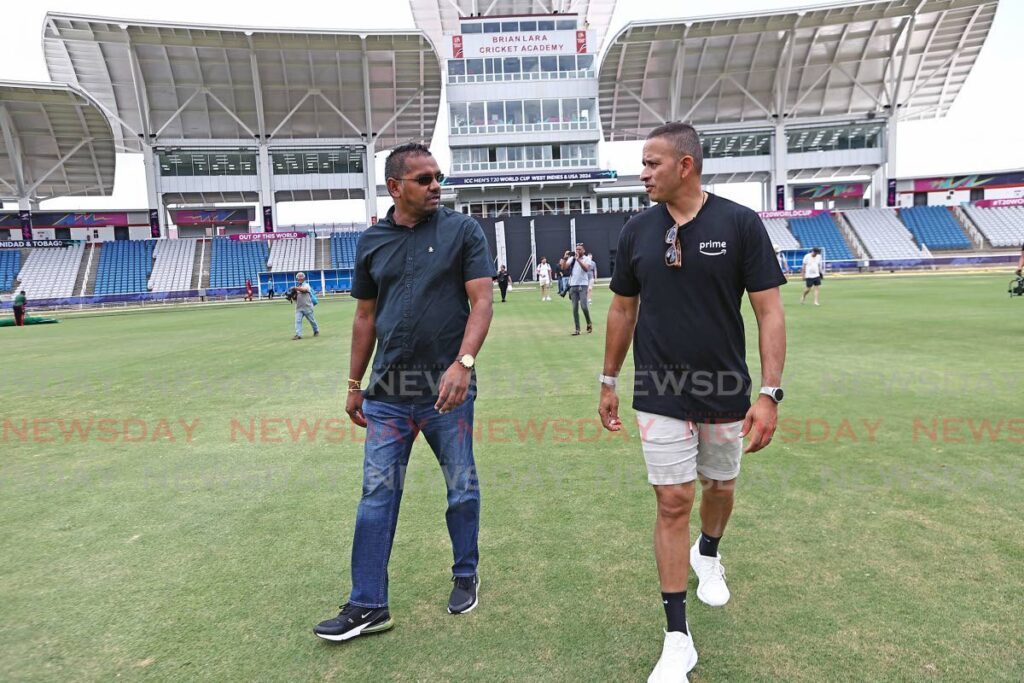 Australian cricketer Usman Khawaja (R) chats with Udecott facilitator Shivanand Ramoutar during a media tour of the playing pitch at the Brian Lara CRicket Academy in Tarouba on Monday.  - Lincoln Holder 