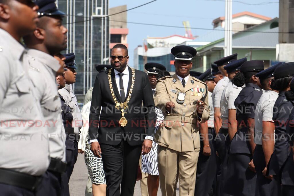 Port of Spain mayor Chinua Alleyne and Snr Supt Glenn Charles inspect the City Police ranks at Alleyne's first  quarterly inspection parade in front of City Hall on Knox Street on May 28.