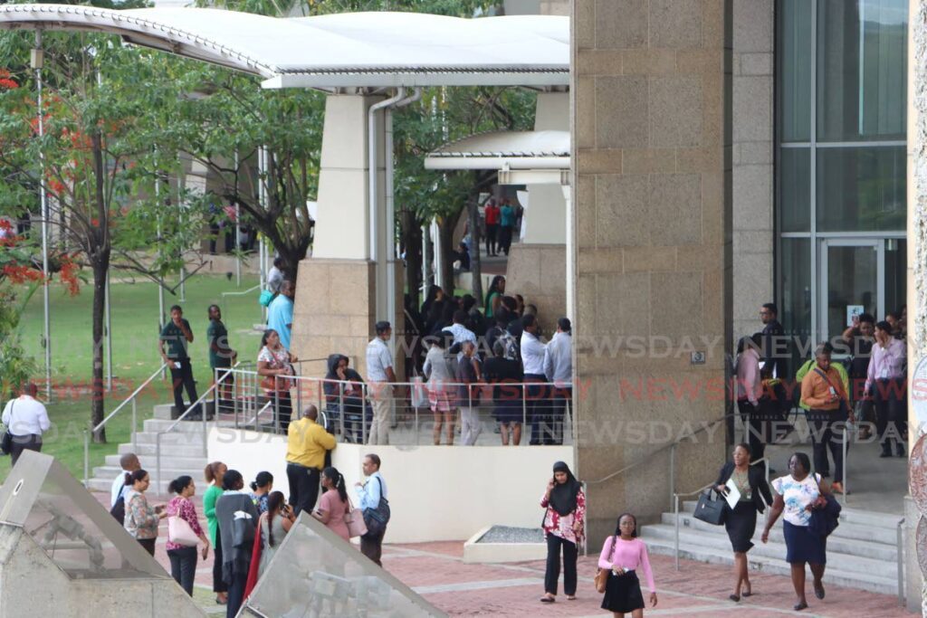 Employees evacuate Towers C and D, International Waterfront Complex, Port of Spain, on May 29.  - Angelo Marcelle