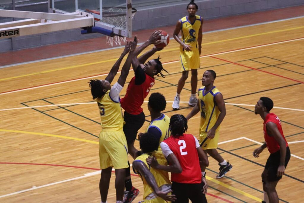 Maloney Pacers' Jaden Simon goes powers to the rim under pressure from Arouca New Age Lions' Adom Belford in Momentum U23 Basketball round two action over the weekend. - Courtesy Momentum Basketball