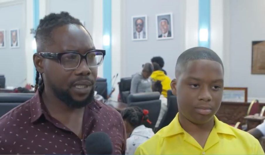 Whim Anglican teacher Wade David with a student ahead of the primary school's plenary debate at the Assembly Legislature, Scarborough. 