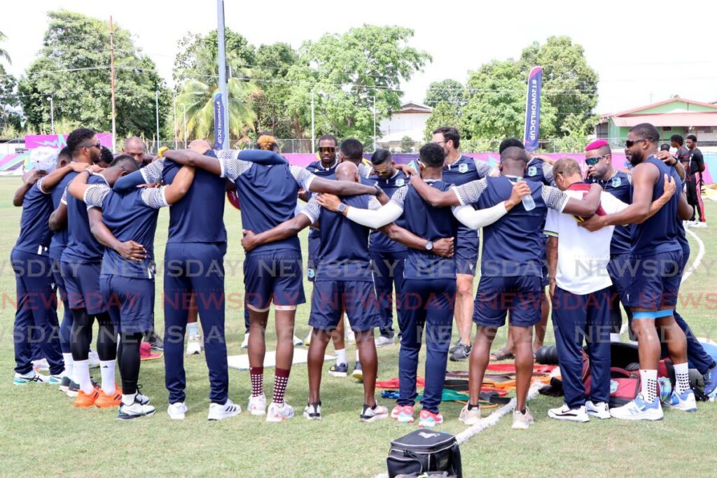 West Indies players and coaches gather in prayer during a team training session, on May 29, at UWI-Spec, 
St Augustine. The West Indies play Papua New Guinea in their first match of the 2024 ICC T20 World Cup on May 2.  - AYANNA KINSALE