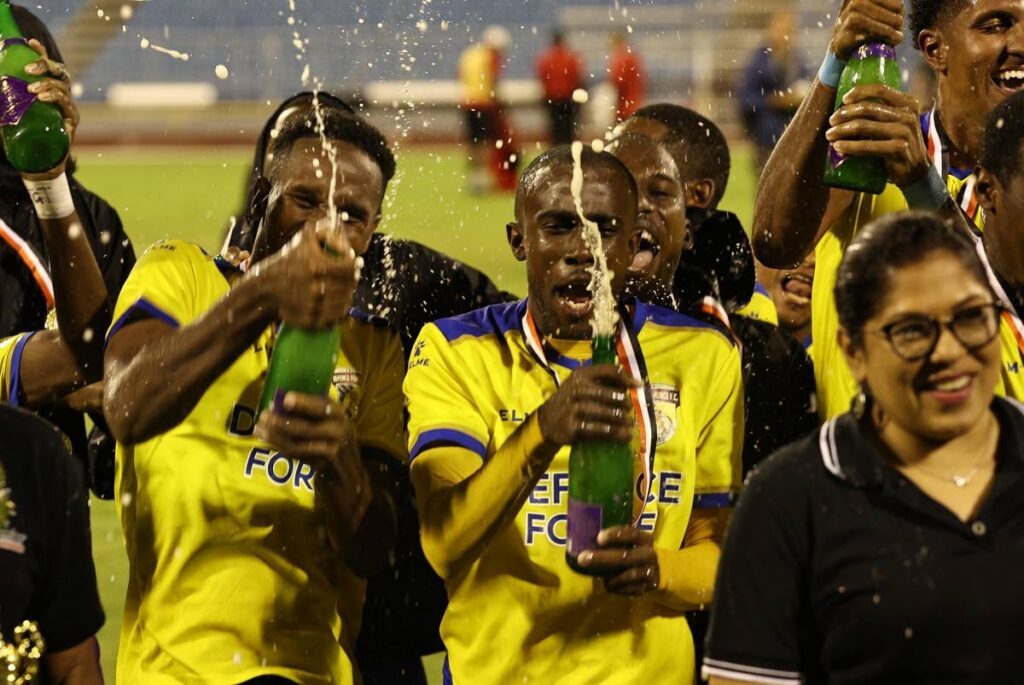 Memebers of Defence Force FC celebrate after claiming the 2024 First Citizens Knockout Cup title when they got a comprehensive 3-1 victory against AC PoS in the final at the Hasely Crawford Stadium, Mucurapo on May 29. - (TTPFL)