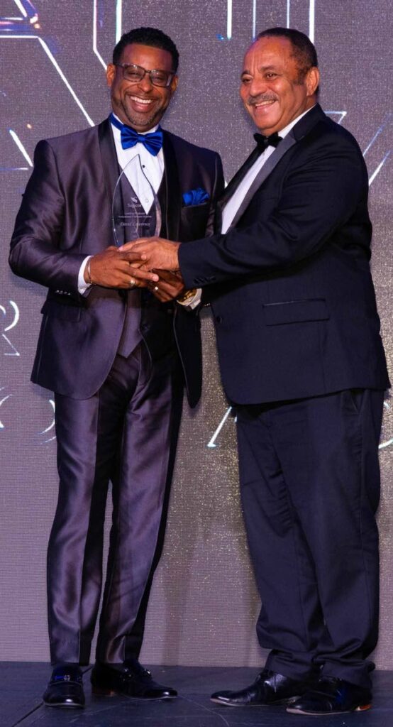 STAR PERFORMER: David Lawrence, accepts the award for Leading Producer, NAC and API from Donald Austin, CEO of Sagicor Life Eastern Caribbean Inc. - Photo courtesy Sagicor