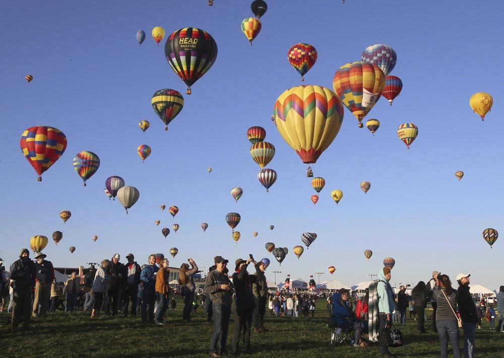 Spectators watch hot air balloons lift off. AP PHOTO - 