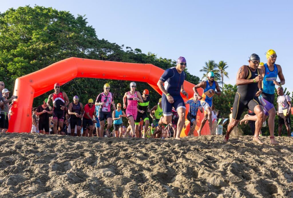 Athletes race to the water for the swim category of the Rainbow Cup on June 10, 2023 at Turtle Beach, Black Rock, Tobago.  - David Reid