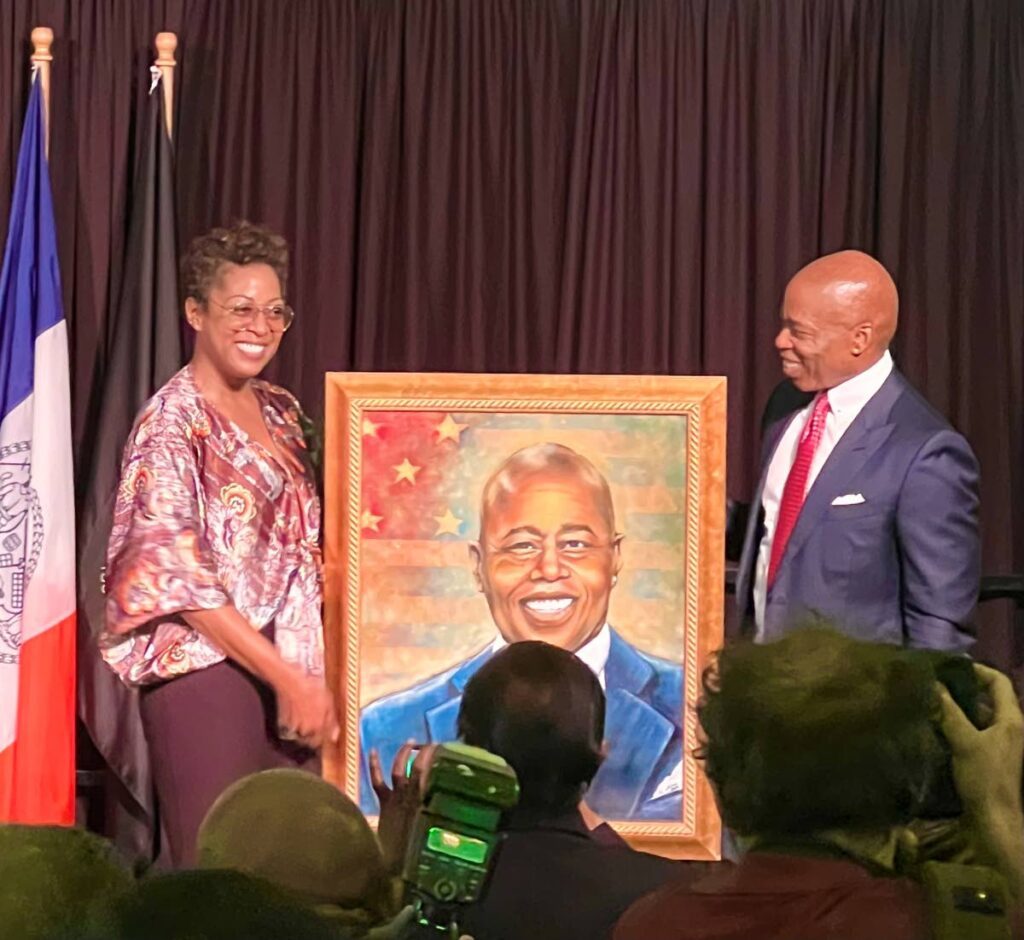 Artist Alicia Aberdeen-Jones, left, and New York mayor Eric Adams show off her portrait of Adams at Gracie Mansion. - 