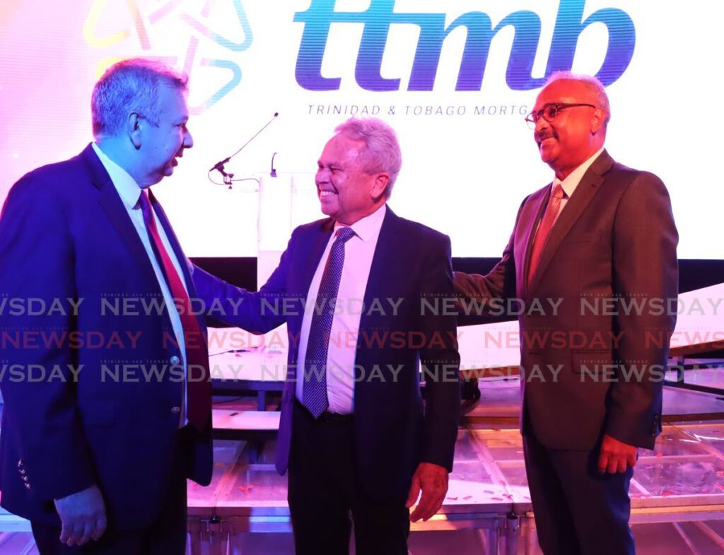 Finance Minister Colm Imbert, centre, speaks with chairman of the National Insurance Board, Trinidad and Tobago Mortgage Finance Company and Home Mortgage Patrick Ferreira, left, and CEO of Trinidad and Tobago Mortgage Bank Robert Green during the TTMB brand launch at the Hyatt Regency, Port of Spain, on March 20. - Photo by Ayanna Kinsale  