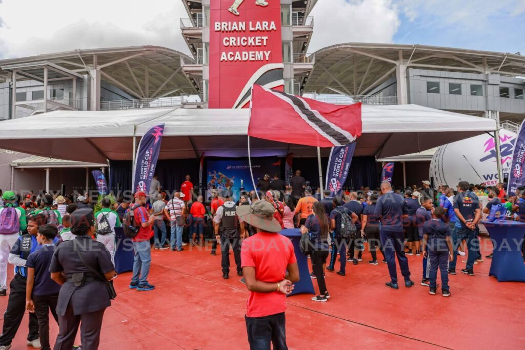 Police keep a watchful eye as fans get a closer look at the ICC T20 World Cup trophy at the Brian Lara Cricket Academy, Tarouba on May 18.  - Photo by Jeff K Mayers