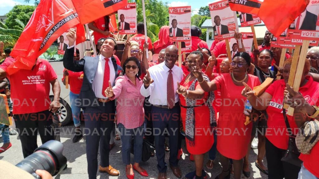 PNM candidate Autly Granthume, centre, is welcomed with a party of flag-flying supporters, tassa and African drummers as well as Local Government Minister Faris Al-Rawi, second from left, and Trade Minister Paula Gopee Scoon, third from left, as he filed his nomination papers at the Princes Town East Secondary School on May 24. - Photo by Yvonne Webb